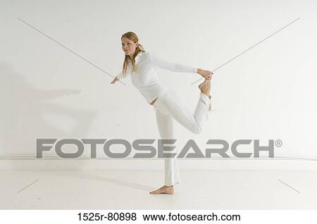 Side profile of a young woman exercising View Large Photo Image Stock Photo - Side profile of a young woman exercising. Fotosearch