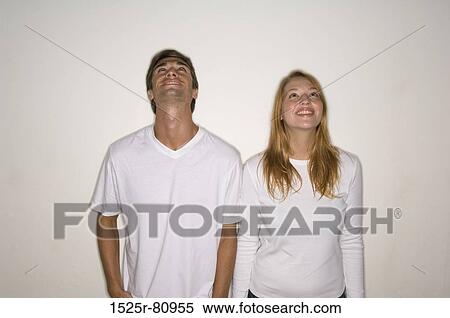 Young couple standing together and smiling View Large Photo Image Stock Photography - Young couple standing together and smiling. Fotosearch