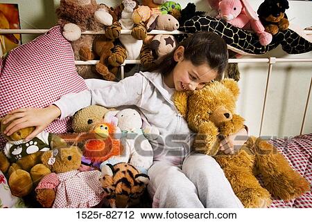 Girl playing with stuffed toys and smiling in a bedroom View Large Photo Image Stock Image - Girl playing with stuffed toys and smiling in a bedroom. Fotosearch