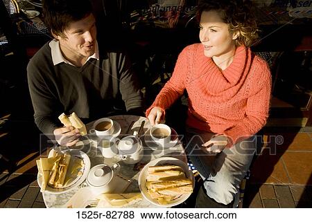 High angle view of a young couple sitting in a sidewalk cafe View Large Photo Image Stock Photo - High angle view of a young couple sitting in a sidewalk cafe. Fotosearch
