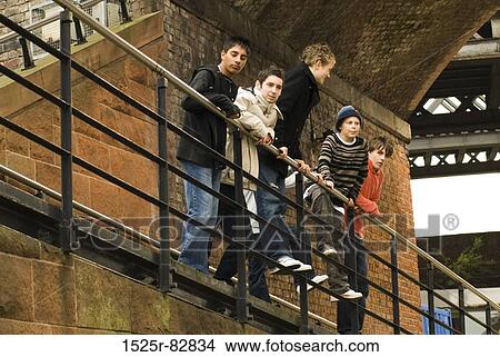 Low angle view of five teenage boys standing near a railing View Large Photo Image Picture - Low angle view of five teenage boys standing near a railing. Fotosearch