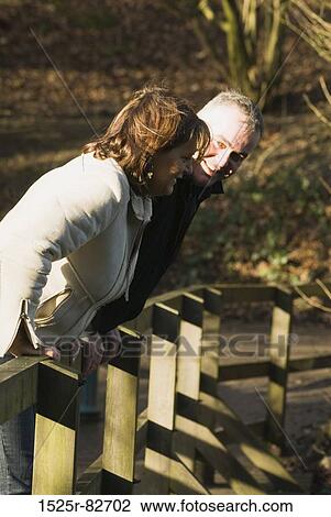 Mature couple leaning on a fence View Large Photo Image Stock Image - Mature couple leaning on a fence. Fotosearch