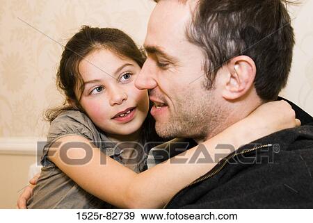 Mid adult man hugging his daughter View Large Photo Image Stock Photo - Mid adult man hugging his daughter. Fotosearch