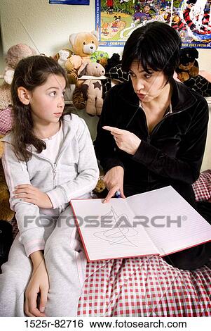 Mid adult woman scolding her daughter View Large Photo Image Stock Photograph - Mid adult woman scolding her daughter. Fotosearch