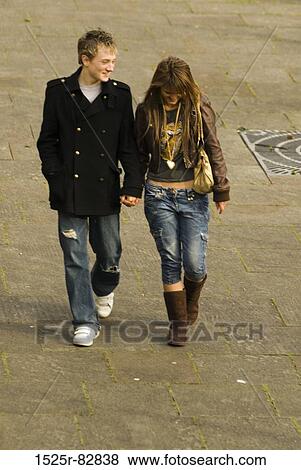 Teenage boy and a teenage girl walking on the road View Large Photo Image Stock Photo - Teenage boy and a teenage girl walking on the road. Fotosearch