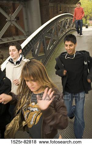 Teenage boys and teenage girls running on a bridge View Large Photo Image Stock Photo - Teenage boys and teenage girls running on a bridge. Fotosearch