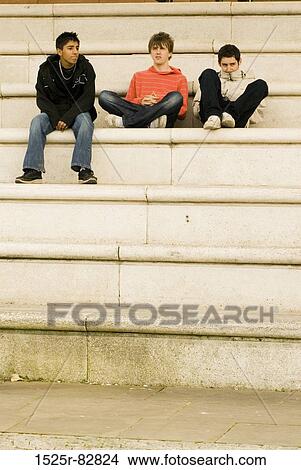 Three teenage boys sitting on steps View Large Photo Image Picture - Three teenage boys sitting on steps. Fotosearch
