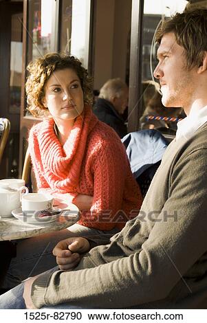 Young couple sitting in a sidewalk cafe View Large Photo Image Stock Image - Young couple sitting in a sidewalk cafe. Fotosearch