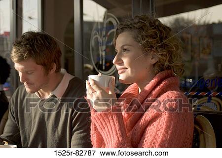 Young couple sitting in a sidewalk cafe View Large Photo Image Stock Photo - Young couple sitting in a sidewalk cafe. Fotosearch
