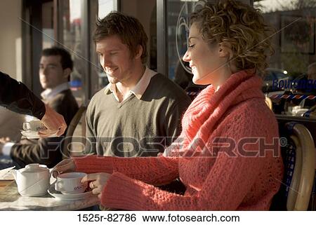 Stock Photograph - Young couple sitting in a sidewalk cafe. Fotosearch