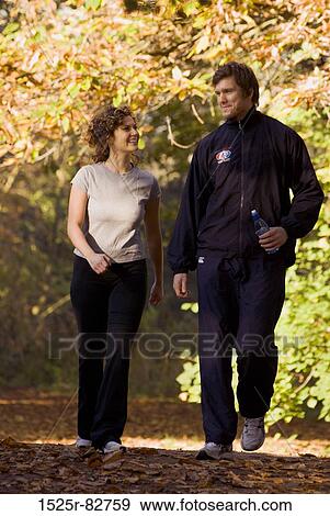 Stock Photo - Young couple walking in a park. Fotosearch