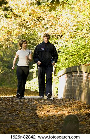 Young couple walking on the road View Large Photo Image Stock Image - Young couple walking on the road. Fotosearch