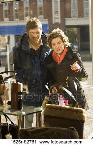 Young couple window shopping View Large Photo Image Stock Image - Young couple window shopping. Fotosearch