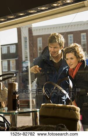 Young couple window shopping View Large Photo Image Stock Image - Young couple window shopping. Fotosearch