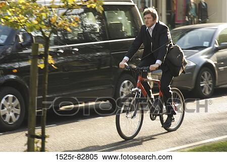 Young man riding a bicycle View Large Photo Image Stock Photography - Young man riding a bicycle. Fotosearch