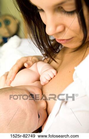 Stock Photo - Young woman breastfeeding a baby. Fotosearch