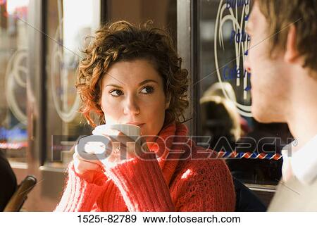 Young woman drinking a cup of tea in a sidewalk cafe View Large Photo Image Stock Photo - Young woman drinking a cup of tea in a sidewalk cafe. Fotosearch