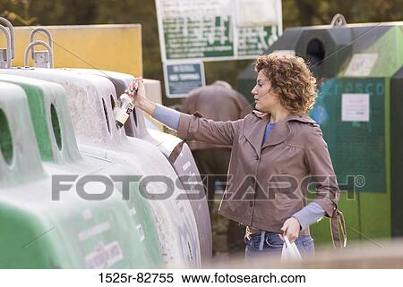 Young woman putting a bottle in a recycling bin View Large Photo Image Stock Photography - Young woman putting a bottle in a recycling bin. Fotosearch