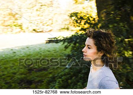 Young woman thinking in a park View Large Photo Image Stock Photo - Young woman thinking in a park. Fotosearch