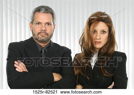 Businessman and a businesswoman with their arms crossed View Large Photo Image Stock Image - Businessman and a businesswoman with their arms crossed. Fotosearch