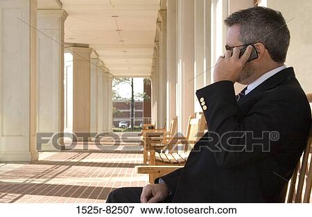 Businessman talking on a mobile phone View Large Photo Image Stock Photo - Businessman talking on a mobile phone. Fotosearch