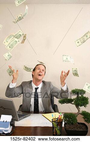 Stock Image - Businessman tossing dollar bills in the air. Fotosearch