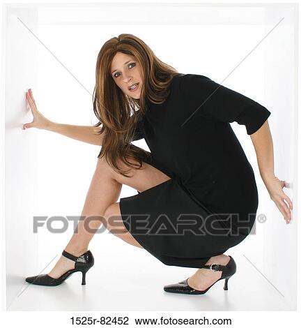 Businesswoman crouching under a low ceiling View Large Photo Image Stock Image - Businesswoman crouching under a low ceiling. Fotosearch