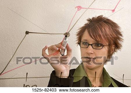 Businesswoman drawing a line graph on a transparent sheet View Large Photo Image Stock Image - Businesswoman drawing a line graph on a transparent sheet. Fotosearch