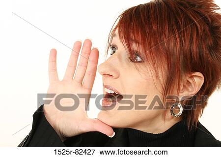 Businesswoman shouting with her hand near her mouth View Large Photo Image Stock Photo - Businesswoman shouting with her hand near her mouth. Fotosearch