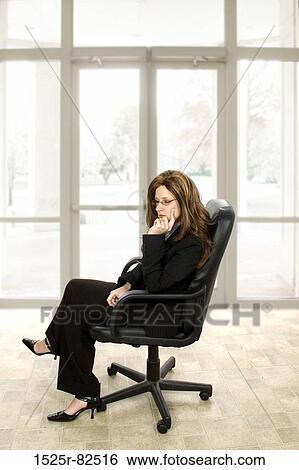 Businesswoman sitting in an office chair View Large Photo Image Stock Photograph - Businesswoman sitting in an office chair. Fotosearch