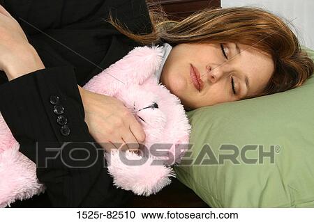 Businesswoman sleeping with a stuffed toy View Large Photo Image Stock Image - Businesswoman sleeping with a stuffed toy. Fotosearch