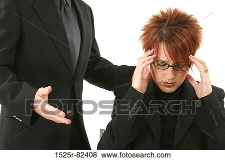 Businesswoman suffering from a headache with a businessman standing beside her View Large Photo Image Stock Photo - Businesswoman suffering from a headache with a businessman standing beside her. Fotosearch