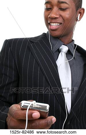 Close-up of a businessman listening to an MP3 player View Large Photo Image Stock Photograph - Close-up of a businessman listening to an MP3 player. Fotosearch