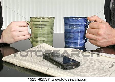 Close-up of a man and a woman's hands holding cups of coffee View Large Photo Image Stock Photo - Close-up of a man and a woman's hands holding cups of coffee. Fotosearch