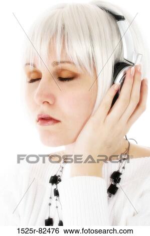 Stock Photograph - Close-up of a young woman listening to music. Fotosearch
