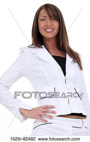 Low angle view of a young woman standing with her hand on her hip and smiling View Large Photo Image Stock Image - Low angle view of a young woman standing with her hand on her hip and smiling. Fotosearch