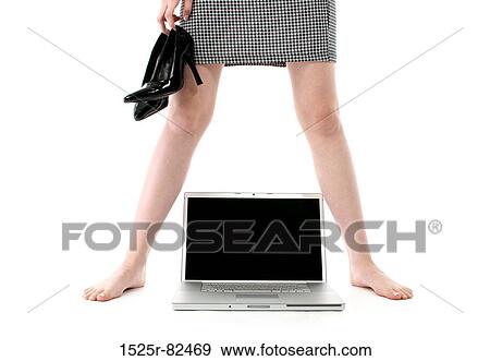 Low section view of a woman standing with a laptop between her legs View Large Photo Image Stock Photo - Low section view of a woman standing with a laptop between her legs. Fotosearch