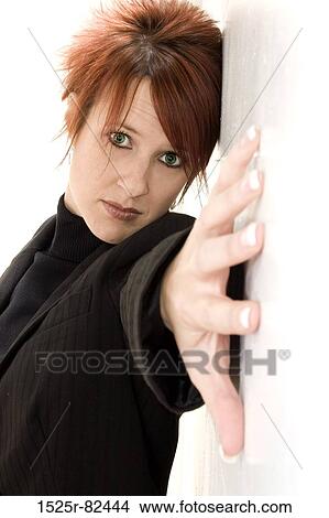 Mid adult woman with her hand stretched across a wall View Large Photo Image Picture - Mid adult woman with her hand stretched across a wall. Fotosearch