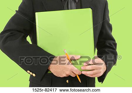 Stock Photo - Mid section view of a businessman holding a file. Fotosearch