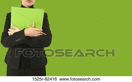 Stock Photograph - Mid section view of a businesswoman holding a file. Fotosearch