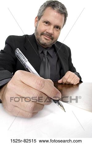 Portrait of a businessman writing on a sheet of paper View Large Photo Image Stock Photography - Portrait of a businessman writing on a sheet of paper. Fotosearch