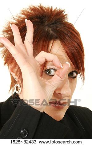 Portrait of a mid adult woman making an OK sign with her fingers over her eye View Large Photo Image Stock Image - Portrait of a mid adult woman making an OK sign with her fingers over her eye. Fotosearch