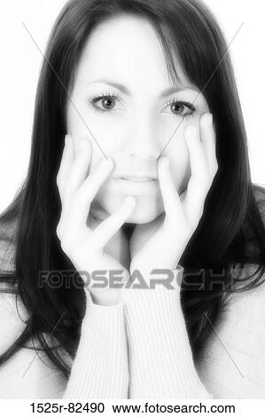 Stock Image - Portrait of a young woman looking serious. Fotosearch