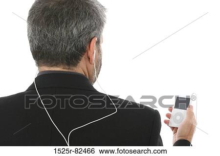 Rear view of a man listening to an MP3 player View Large Photo Image Stock Photograph - Rear view of a man listening to an MP3 player. Fotosearch