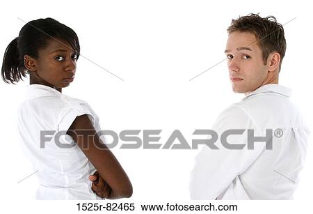 Young woman and a young man standing with their arms crossed View Large Photo Image Stock Photography - Young woman and a young man standing with their arms crossed. Fotosearch