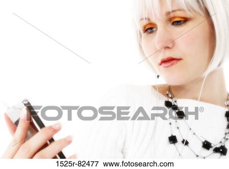 Stock Photo - Young woman listening to music on an MP3 player. Fotosearch