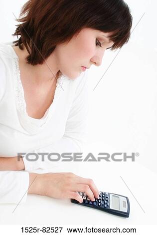 Young woman using a calculator View Large Photo Image Stock Photo - Young woman using a calculator. Fotosearch