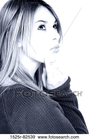 Young woman with her finger on her chin View Large Photo Image Stock Photo - Young woman with her finger on her chin. Fotosearch