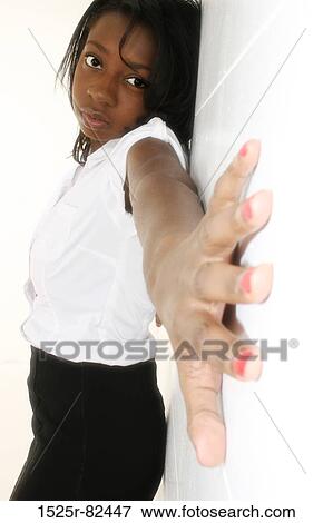 Young woman with her hand stretched across a wall View Large Photo Image Stock Photo - Young woman with her hand stretched across a wall. Fotosearch