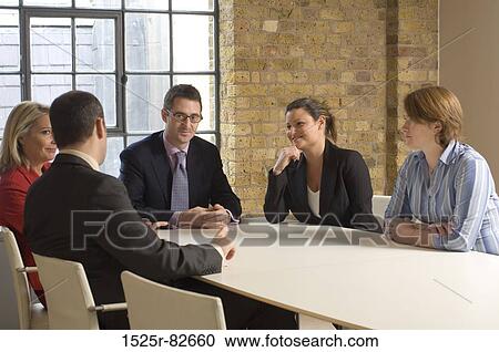 Stock Image - Business executives talking in a meeting. Fotosearch